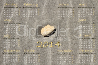 2014 english calendar with stone on sand