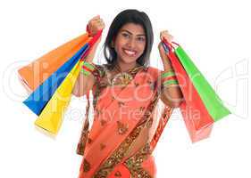 Indian woman in sari dress holding shopping bags