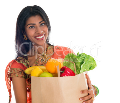 Indian woman in sari dress groceries shopping