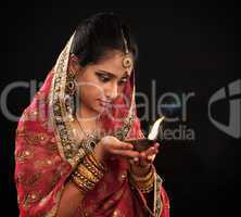 Diwali Indian woman with oil lamp