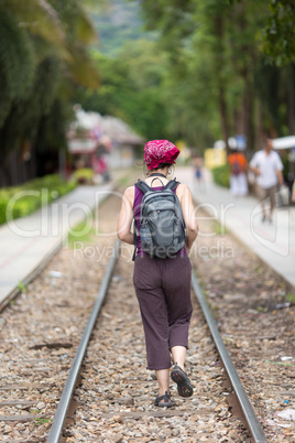 Woman walking on railway