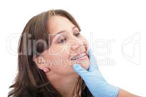 Woman checking his routine brackets on her dentist