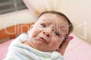 Woman holding a beautiful sweet hispanic newborn crying