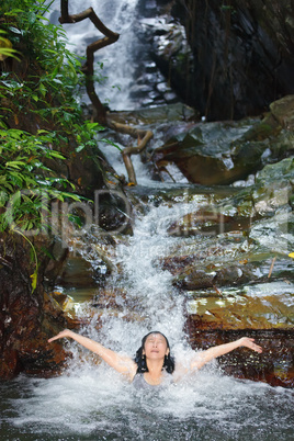 woman in wild waterfall