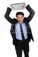 Angry businessman throwing his laptop