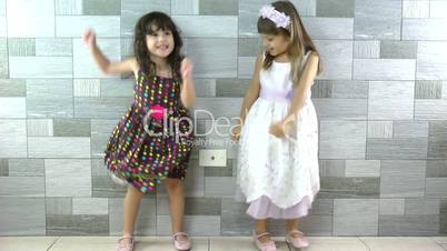 Happy little girls dancing
