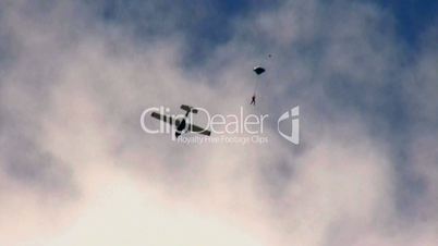 Skydiver jump from the plane and parachuting down to the Earth.