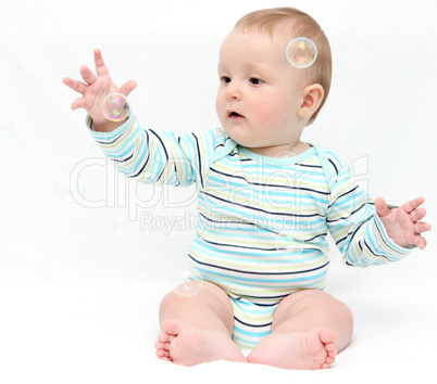 Baby playing with soap bubbles