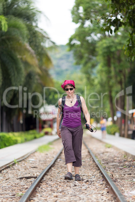 woman walking on railway
