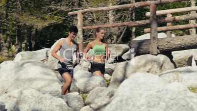 2of4 Young man and woman running on mountain trail, sport