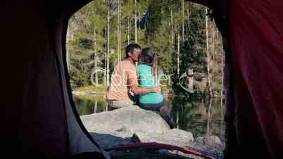 Outdoor activity, young couple camping with tent near mountain lake