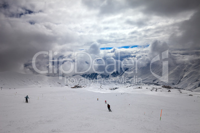 skiers on ski slope before storm