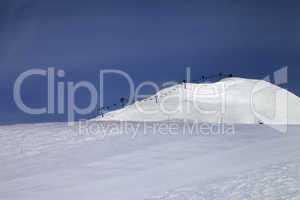 ski slope and ropeway against blue sky