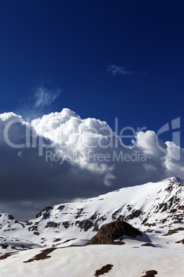 snowy mountains and blue sky with clouds
