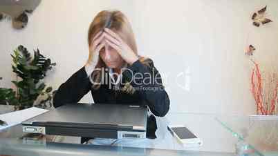 stressed woman working at the laptop