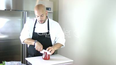 chef cutting peppers for salad