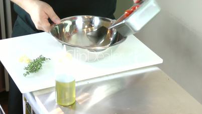 Chef preparing fresh herbs and tomatoes for grilled bbq steaks