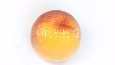 Ripe  peach fruit rotating on white background