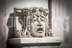 statue head in front of budapest national theater