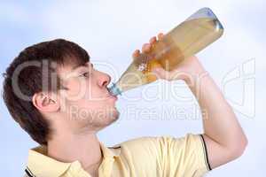 Young man drinking from a bottle