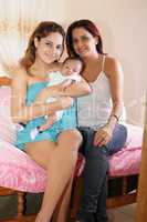 latin mom and sister with cute baby