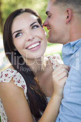 Mixed Race Romantic Couple Whispering in the Park