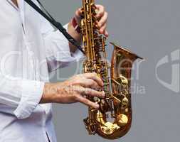 hands of a musician with the saxophone