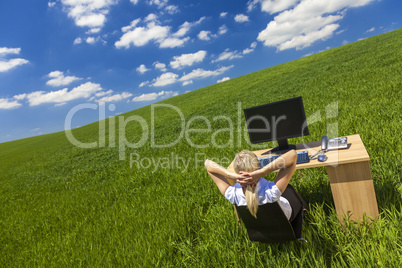 Business Woman Relaxing at Desk in Green Field Office