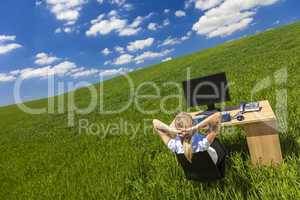 Business Woman Relaxing at Desk in Green Field Office