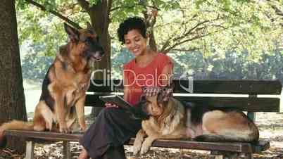 14of15 People, pets, dog sitter with alsatian dogs in park