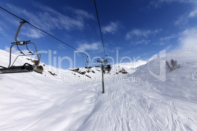 chair-lift with skiers at winter mountains