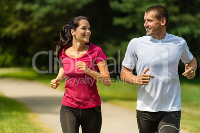 Cheerful Caucasian couple running outdoors