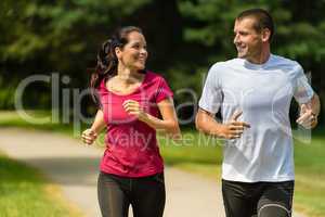 Cheerful Caucasian couple running outdoors