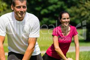 Close up portrait of couple stretching outdoors
