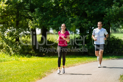 Boyfriend and girlfriend running a race outdoors