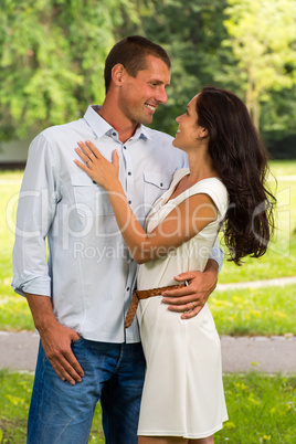 Boyfriend and girlfriend embracing outdoors