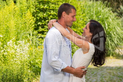 Playful Caucasian couple embracing outdoors