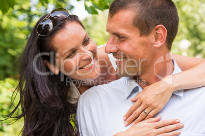 Happy affectionate young couple hugging in park