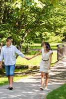 Couple in love holding hands walking park