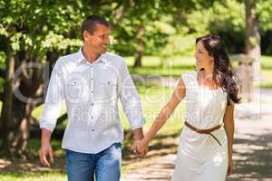 Couple walking and laughing in a park