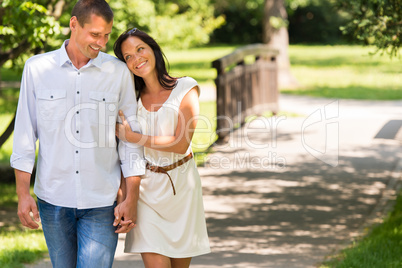 Couple walking in park hand in hand