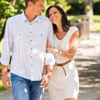 Young happy couple embracing in park