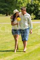 Young couple walking in park barefoot