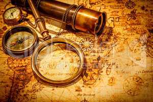 Vintage magnifying glass lies on an ancient world map