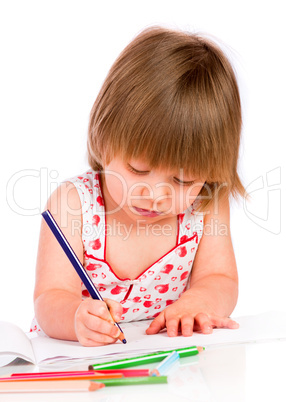 Little baby girl draws pencil