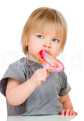 Baby eating a sticky lollipop