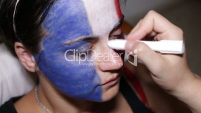 Woman face painting flag of France