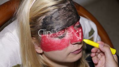Woman face painting flag of Germany