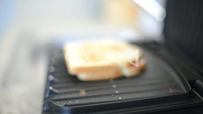 Dolly move in of sandwich on electric grill