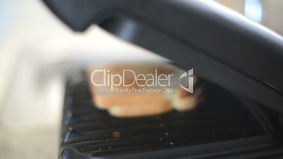 Dolly move in of electric grill opening with sandwich